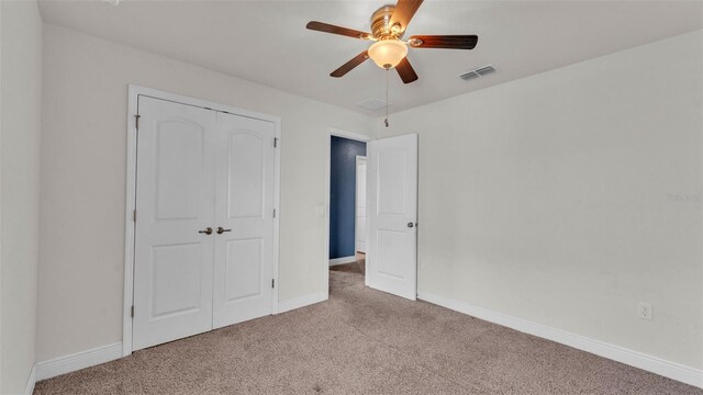 1156 Normandy Heights Cir, Winter Haven, FL 33880 - unfurnished bedroom featuring carpet, a closet, and a ceiling fan