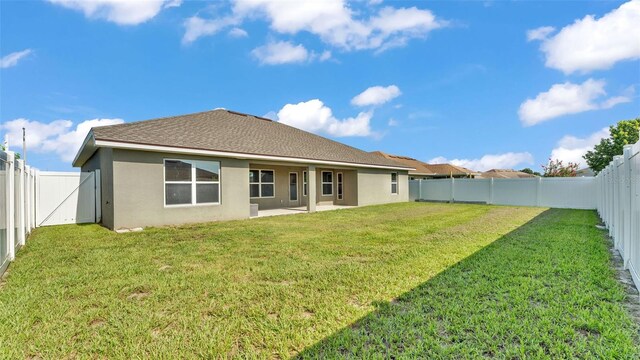 1156 Normandy Heights Cir, Winter Haven, FL 33880 - back of property with stucco siding, a fenced backyard, and a patio