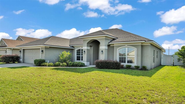 1156 Normandy Heights Cir, Winter Haven, FL 33880 - ranch-style house featuring stucco siding, a garage, a gate, and driveway