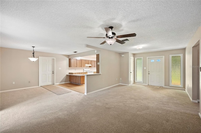 335 W Cummings St, Lake Alfred, FL 33850 - unfurnished living room with light carpet, a ceiling fan, and a textured ceiling