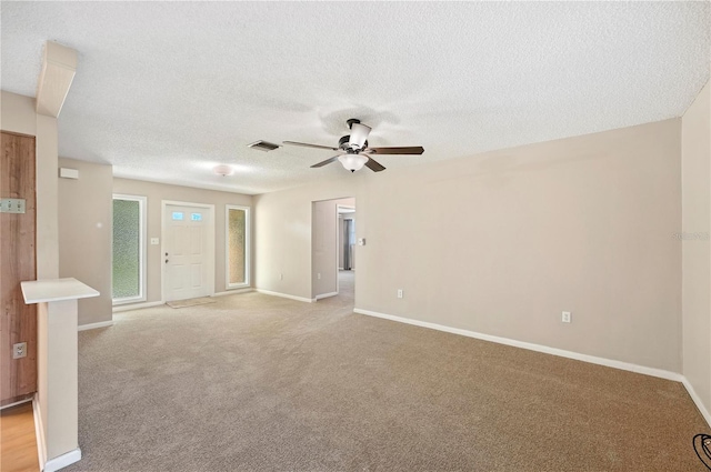 335 W Cummings St, Lake Alfred, FL 33850 - unfurnished living room featuring a ceiling fan, light colored carpet, and a textured ceiling