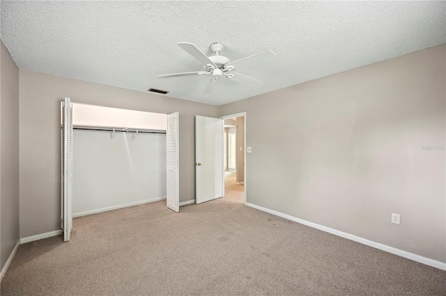 335 W Cummings St, Lake Alfred, FL 33850 - unfurnished bedroom with carpet floors, a closet, ceiling fan, and a textured ceiling