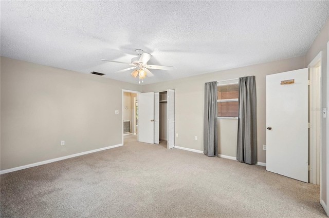 335 W Cummings St, Lake Alfred, FL 33850 - unfurnished bedroom with light colored carpet, a textured ceiling, and ceiling fan