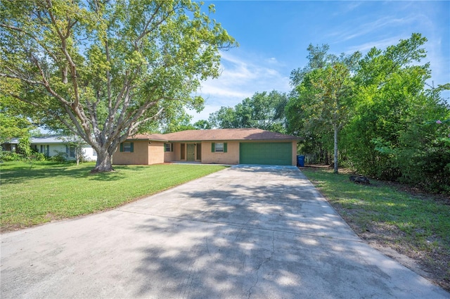 335 W Cummings St, Lake Alfred, FL 33850 - ranch-style house with an attached garage, driveway, and a front lawn