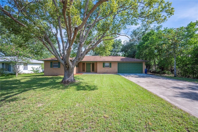 335 W Cummings St, Lake Alfred, FL 33850 - single story home with a garage, driveway, a front yard, and brick siding