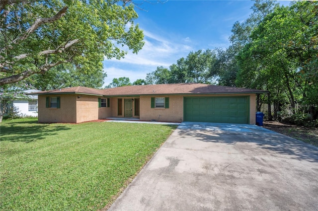 335 W Cummings St, Lake Alfred, FL 33850 - ranch-style home featuring a garage, concrete driveway, a front yard, and brick siding