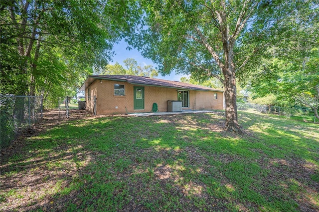335 W Cummings St, Lake Alfred, FL 33850 - back of house with a fenced backyard and brick siding