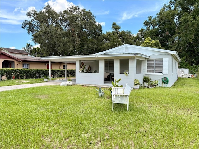 1302 W 8th St, Lakeland, FL 33805 - view of front of home with a carport, driveway, and a front lawn