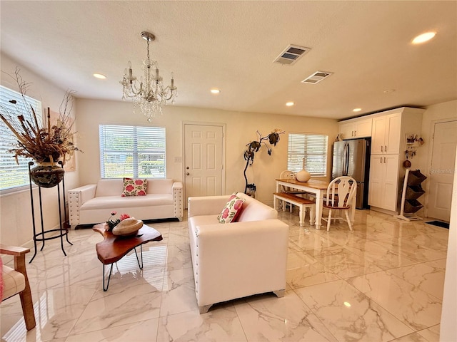 1302 W 8th St, Lakeland, FL 33805 - living area with recessed lighting, a chandelier, light marble finish floors, and a textured ceiling