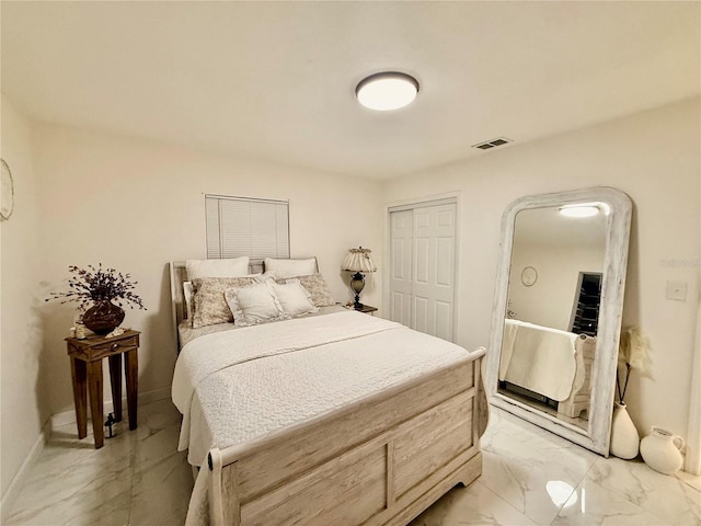1302 W 8th St, Lakeland, FL 33805 - bedroom featuring light marble finish floors and a closet