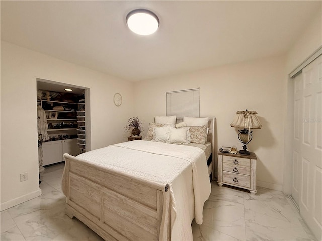 1302 W 8th St, Lakeland, FL 33805 - bedroom featuring light marble finish flooring and a walk in closet