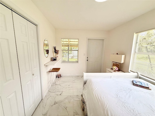 1302 W 8th St, Lakeland, FL 33805 - bedroom featuring marble finish floors and a closet