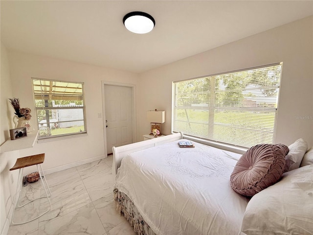 1302 W 8th St, Lakeland, FL 33805 - bedroom with light marble finish floors and baseboards