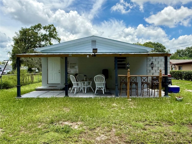 1302 W 8th St, Lakeland, FL 33805 - rear view of property featuring a lawn and a patio