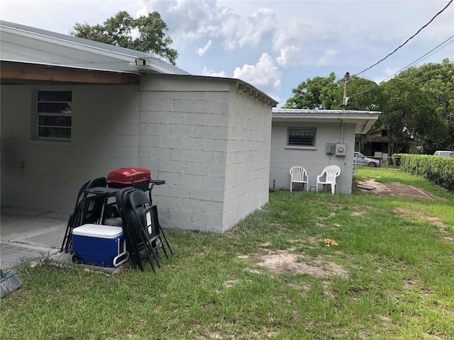 1302 W 8th St, Lakeland, FL 33805 - view of home's exterior with concrete block siding and a lawn