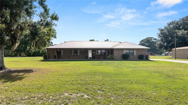 6504 Hereford Dr, Lakeland, FL 33810 - view of front of house featuring a front yard and a metal roof