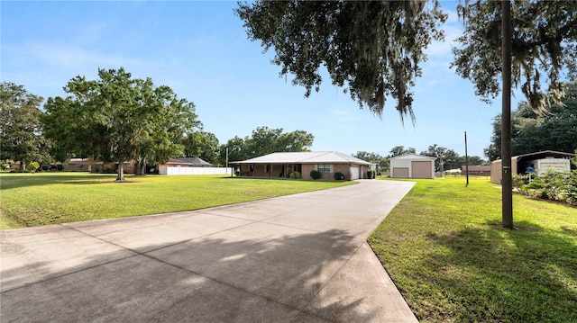 6504 Hereford Dr, Lakeland, FL 33810 - ranch-style home featuring a front yard, a detached garage, an outdoor structure, and concrete driveway