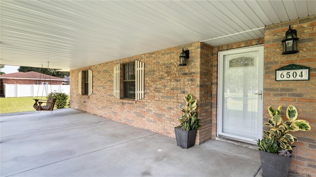 6504 Hereford Dr, Lakeland, FL 33810 - view of exterior entry featuring brick siding and a porch