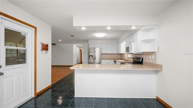 6504 Hereford Dr, Lakeland, FL 33810 - kitchen featuring stainless steel appliances, white cabinetry, a peninsula, backsplash, and open shelves
