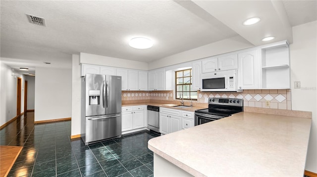 6504 Hereford Dr, Lakeland, FL 33810 - kitchen featuring stainless steel appliances, a peninsula, open shelves, white cabinetry, and recessed lighting