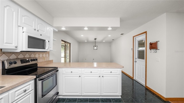 6504 Hereford Dr, Lakeland, FL 33810 - kitchen with electric stove, white microwave, a peninsula, light countertops, and white cabinets
