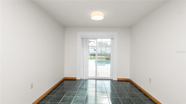 6504 Hereford Dr, Lakeland, FL 33810 - unfurnished room featuring baseboards and dark tile patterned floors
