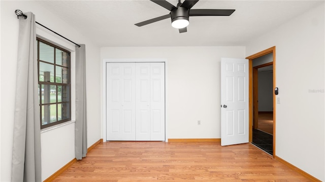 6504 Hereford Dr, Lakeland, FL 33810 - unfurnished bedroom with light wood-style floors, multiple windows, a closet, and a ceiling fan
