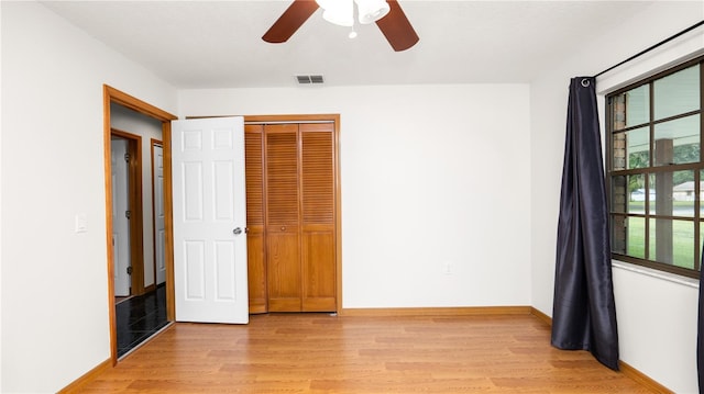 6504 Hereford Dr, Lakeland, FL 33810 - unfurnished bedroom with light wood finished floors, a closet, and a ceiling fan