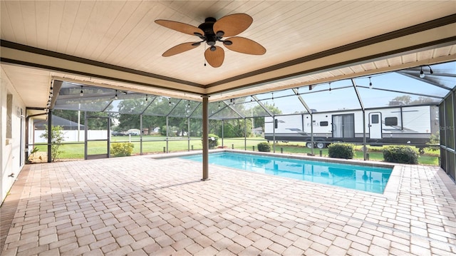 6504 Hereford Dr, Lakeland, FL 33810 - outdoor pool featuring glass enclosure, a patio, and a ceiling fan