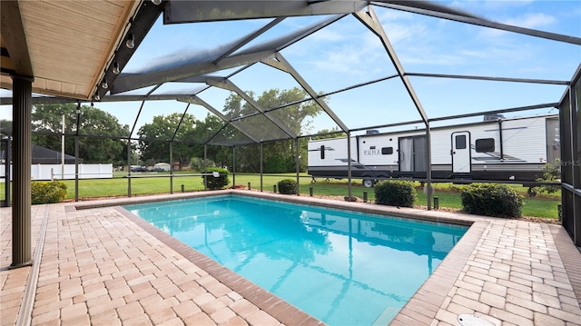 6504 Hereford Dr, Lakeland, FL 33810 - swimming pool featuring a patio, a lawn, and glass enclosure