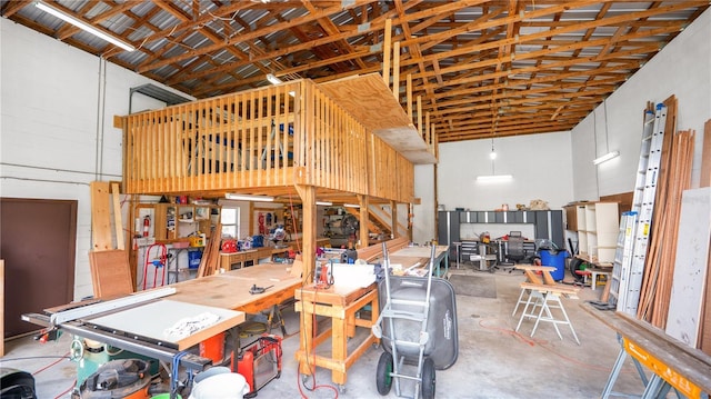 6504 Hereford Dr, Lakeland, FL 33810 - miscellaneous room featuring a towering ceiling, a workshop area, and concrete floors