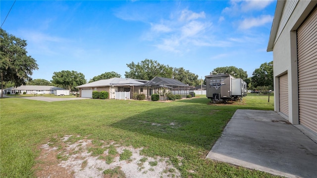 6504 Hereford Dr, Lakeland, FL 33810 - view of green lawn with driveway and a garage