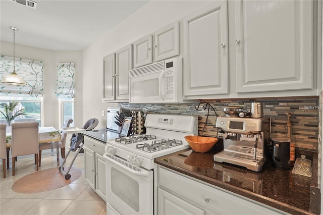 3999 Whistlewood Cir, Lakeland, FL 33811 - kitchen featuring white appliances, decorative backsplash, pendant lighting, light tile patterned floors, and white cabinetry