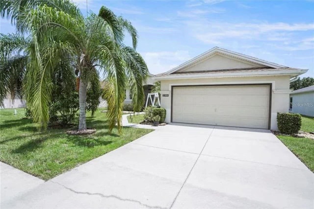 3999 Whistlewood Cir, Lakeland, FL 33811 - single story home featuring stucco siding, driveway, a front yard, and an attached garage