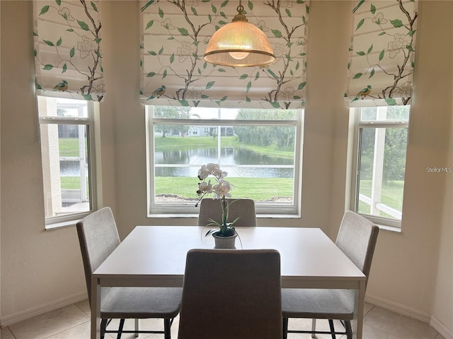 3999 Whistlewood Cir, Lakeland, FL 33811 - dining room featuring a water view, plenty of natural light, and light tile patterned floors