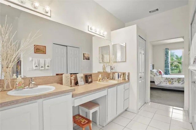 3999 Whistlewood Cir, Lakeland, FL 33811 - bathroom featuring double vanity, ensuite bathroom, tile patterned floors, and tasteful backsplash
