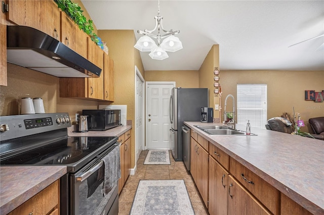735 Virginia Ave, Auburndale, FL 33823 - kitchen with stainless steel appliances, under cabinet range hood, a chandelier, brown cabinetry, and light tile patterned flooring