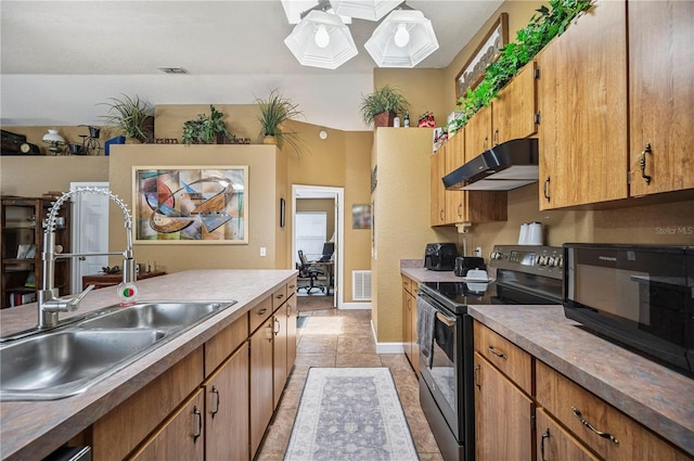 735 Virginia Ave, Auburndale, FL 33823 - kitchen with black appliances, under cabinet range hood, and brown cabinets