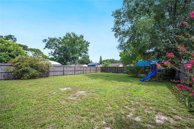735 Virginia Ave, Auburndale, FL 33823 - fenced backyard featuring a playground