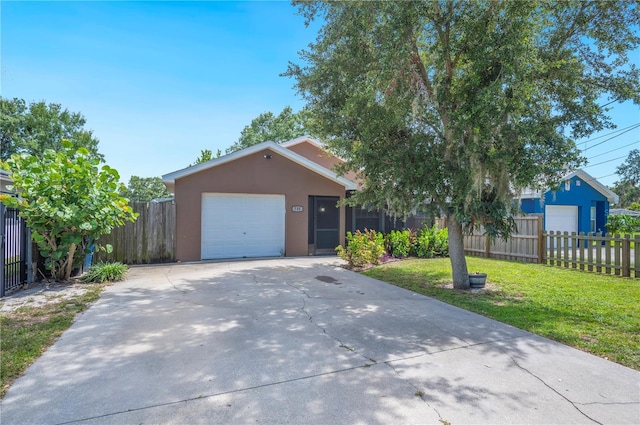 735 Virginia Ave, Auburndale, FL 33823 - view of front of property with driveway, stucco siding, and a garage