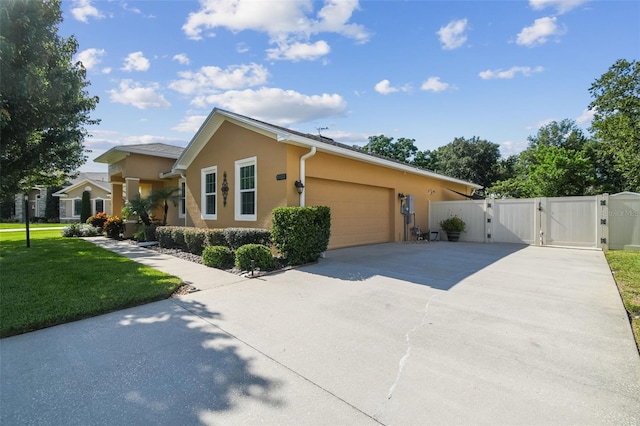 1933 Griffin Trl, Bartow, FL 33830 - view of front facade with a gate, a garage, driveway, and stucco siding