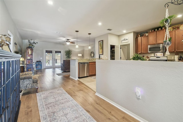 1933 Griffin Trl, Bartow, FL 33830 - kitchen featuring appliances with stainless steel finishes, brown cabinets, a peninsula, open floor plan, and french doors