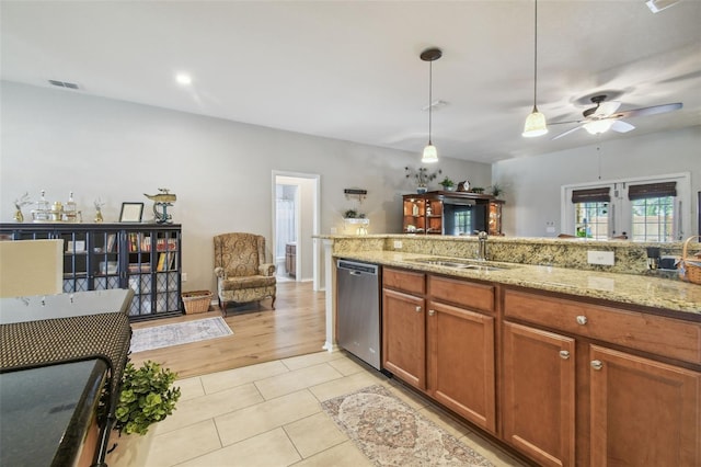 1933 Griffin Trl, Bartow, FL 33830 - kitchen featuring dishwasher, ceiling fan, decorative light fixtures, light tile patterned floors, and brown cabinetry
