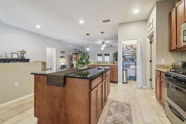 1933 Griffin Trl, Bartow, FL 33830 - kitchen featuring appliances with stainless steel finishes, ceiling fan, a center island, light tile patterned floors, and recessed lighting