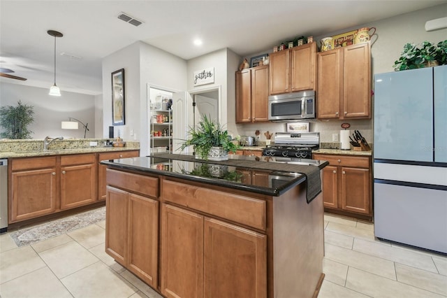 1933 Griffin Trl, Bartow, FL 33830 - kitchen with freestanding refrigerator, stainless steel microwave, range with gas stovetop, light tile patterned flooring, and recessed lighting