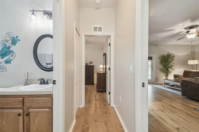 1933 Griffin Trl, Bartow, FL 33830 - hallway with a sink and light wood-style flooring