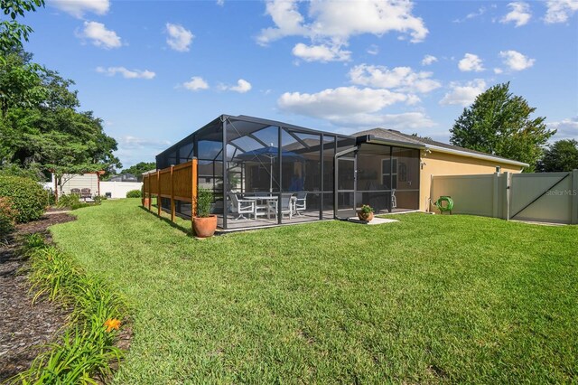 1933 Griffin Trl, Bartow, FL 33830 - rear view of property with a fenced backyard, a patio, glass enclosure, and a gate