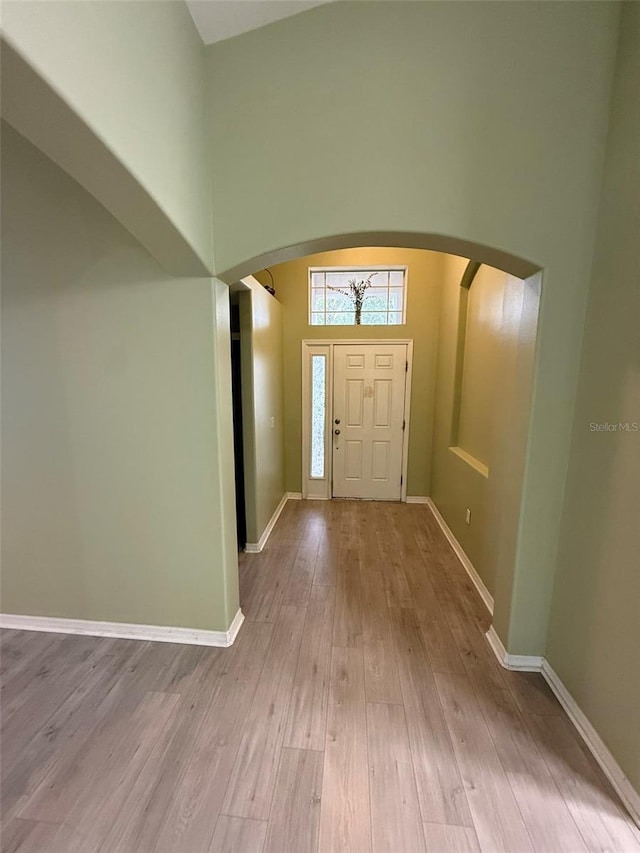 7198 Cedarcrest Blvd, Lakeland, FL 33810 - entryway featuring arched walkways, wood finished floors, and a high ceiling