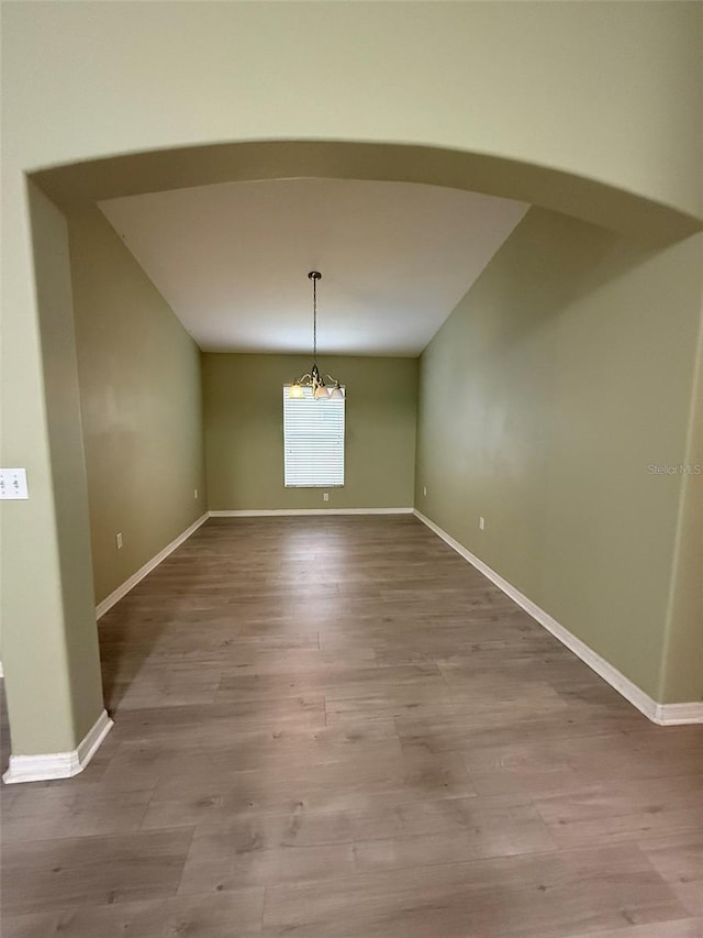 7198 Cedarcrest Blvd, Lakeland, FL 33810 - unfurnished dining area with a chandelier and wood finished floors