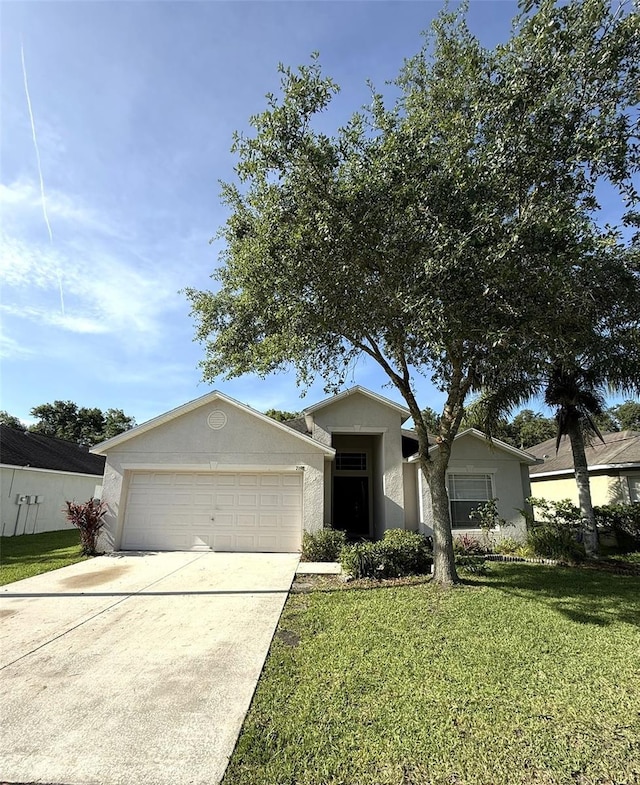 7198 Cedarcrest Blvd, Lakeland, FL 33810 - single story home with concrete driveway, a front lawn, an attached garage, and stucco siding